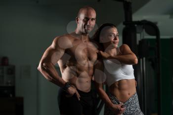 Portrait Of A Sexy Couple In The Gym With Exercise Equipment