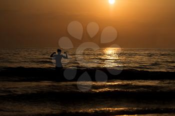 Girl Silhouette On The Beach At Sunset Over The Sea Flexing Muscles - Copy Space Text
