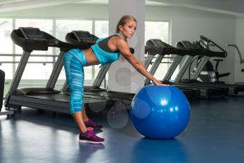 Mature Fitness Woman Working Out In Gym Fitness Center On Ball