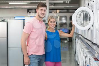 Beautiful Young Couple Shopping For Washing Machine In Produce Department Of A Grocery Store - Supermarket - Shallow Deep Of Field