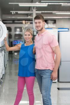 Beautiful Young Couple Shopping For Washing Machine In Produce Department Of A Grocery Store - Supermarket - Shallow Deep Of Field