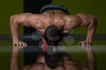 Muscular Adult Athlete Doing Push Ups As Part Of Bodybuilding Training