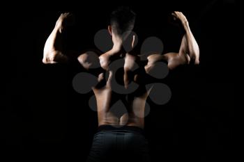 Silhouette Healthy Man Standing Strong In The Gym And Flexing Muscles - Muscular Athletic Bodybuilder Fitness Model Posing After Exercises