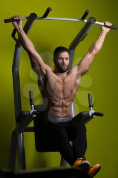 Healthy Man Performing Hanging Leg Raises Exercise - One Of The Most Effective Ab Exercises