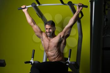 Muscular Man Performing Hanging Leg Raises Exercise - One Of The Most Effective Ab Exercises