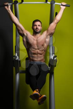 Healthy Man Performing Hanging Leg Raises Exercise - One Of The Most Effective Ab Exercises
