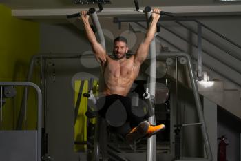 Muscular Man Performing Hanging Leg Raises Exercise - One Of The Most Effective Ab Exercises