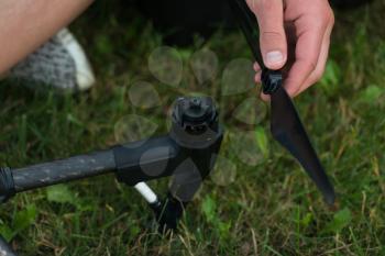 Closeup of Young Engineer Tightening Propeller of Uav Drone With Hand Tool in Park