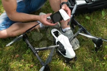 Closeup of Young Engineer Man Checking the Battery of Uav Drone With Hand Tool in Park