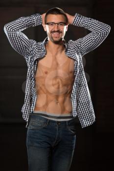 Portrait Of A Young Physically Fit Man In Jeans And T-shirt Showing His Well Trained Body - Muscular Athletic Bodybuilder Fitness Model Posing After Exercises