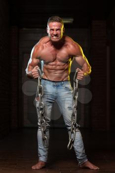 Healthy Young Man Exercising Biceps With Chains