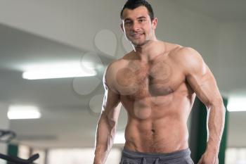 Hairy Handsome Young Man Standing Strong In The Gym And Flexing Muscles - Muscular Athletic Bodybuilder Fitness Model Posing After Exercises