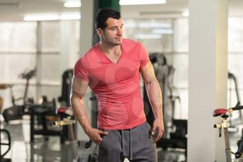 Portrait of a Young Physically Fit Man in Pink T-shirt Showing His Well Trained Body - Muscular Athletic Bodybuilder Fitness Model Posing After Exercises