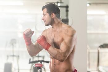 Handsome Man In Red Boxing Gloves - Boxing In Gym - The Concept Of A Healthy Lifestyle - The Idea For The Film About Boxing