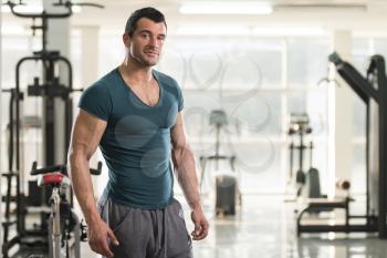 Portrait of a Young Physically Fit Man in Green T-shirt Showing His Well Trained Body - Muscular Athletic Bodybuilder Fitness Model Posing After Exercises