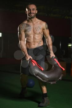 Handsome Man Performing Bag Exercise Indoors In Gym