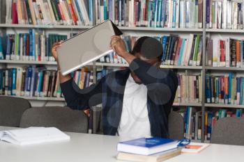 African Male Student Throwing Laptop And Want To Destroy It - Shallow Depth Of Field