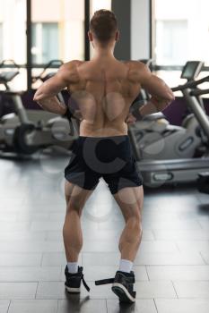 Handsome Man Standing Strong In A Modern Gym And Flexing Muscles - Muscular Athletic Bodybuilder Fitness Model Posing After Exercises