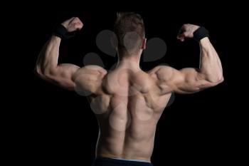 Young Bodybuilder Flexing Muscles - Isolate On Black Blackground - Copy Space