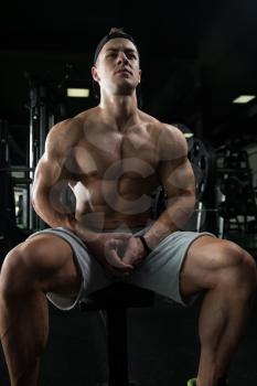 Resting Time - Confident Muscled Young Man Resting In Healthy Club Gym After Exercising