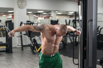 Athlete Is Working On His Chest With Cable Crossover In Gym