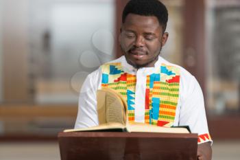 Black African Muslim Man Is Reading The Koran