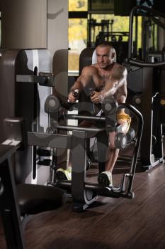 Handsome Athlete Doing Heavy Weight Exercise For Back On Machine