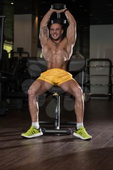 Athlete Working Out Triceps In A Gym With Dumbbell