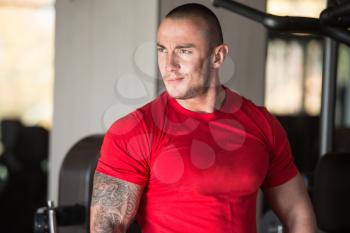 Portrait Of A Muscular Man In Shorts And Red T-shirt Posing