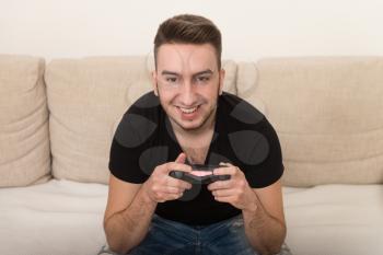 Man Competitive Playing Video Games and Excited Happy Cheerful at Home