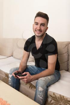 Man Competitive Playing Video Games and Excited Happy Cheerful at Home