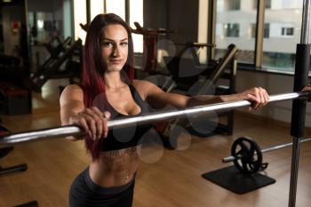 Healthy Fitness Woman Preparing To Working Out Legs With Barbell In A Gym - Squat Exercise