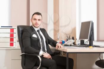 Portrait Of A Young Business Man Using A Computer In The Office