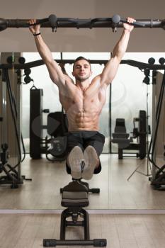 Athlete Performing Hanging Leg Raises Exercise - One Of The Most Effective Ab Exercises