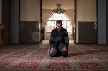 Adult Muslim Man Is Praying In The Mosque