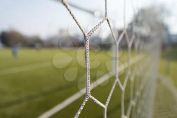 White Soccer or Football Net With Blurred Field Background