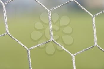 White Soccer or Football Goal Net Against Green Grass