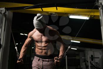 Man In The Gym Exercising On His Chest With Cable Crossover In Gym