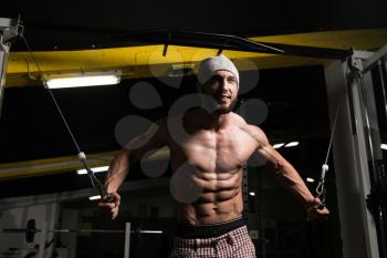 Bodybuilder Is Working On His Chest With Cable Crossover In Gym