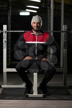 Portrait Of A Physically Fit Man In Track Suit Resting His Well Trained Body - Muscular Athletic Bodybuilder Fitness Model Posing After Exercises