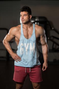 Portrait Of A Young Physically Fit Man In Blue Undershirt Showing His Well Trained Body - Muscular Athletic Bodybuilder Fitness Model Posing After Exercises