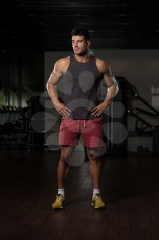 Portrait Of A Young Physically Fit Man In Black Undershirt Showing His Well Trained Body - Muscular Athletic Bodybuilder Fitness Model Posing After Exercises