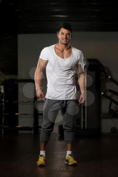 Portrait of a Young Physically Fit Man in White T-shirt Showing His Well Trained Body - Muscular Athletic Bodybuilder Fitness Model Posing After Exercises