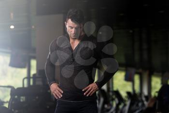 Handsome Young Man Standing Strong in  Black T-shirt Long Sleevs and Flexing Muscles - Muscular Athletic Bodybuilder Fitness Model Posing After Exercises