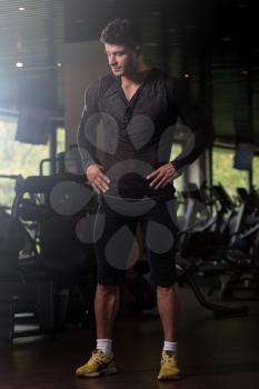 Healthy Young Man in Black T-shirt Long Sleevs Standing Strong and Flexing Muscles - Muscular Athletic Bodybuilder Fitness Model Posing After Exercises
