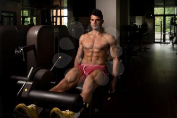 Leg Exercises - Man Doing Leg With Machine In Gym