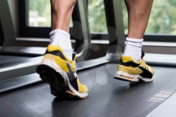 Close-up Of Male Legs Running On Treadmill - Blurred Motion