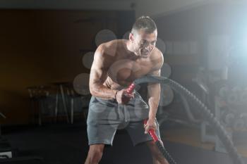 Battling Ropes Young Man At Gym Workout Exercise