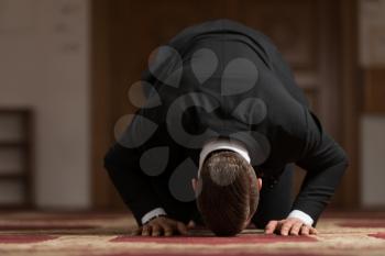Businessman Muslim Making Traditional Prayer to God Allah in the Mosque