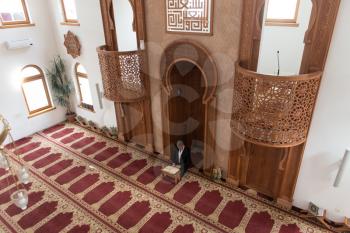 Businessman Muslim Is Reading The Koran Making Traditional Prayer to God Allah in the Mosque